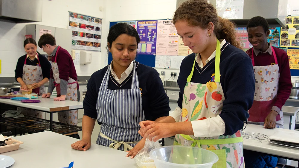 Students preparing food in Home Economics class - St.Louis Community School